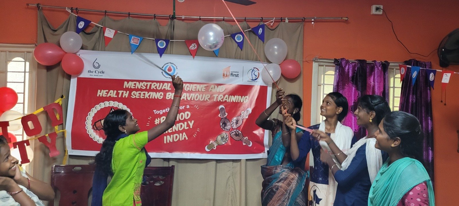 Girls breaking balloons containing taboos