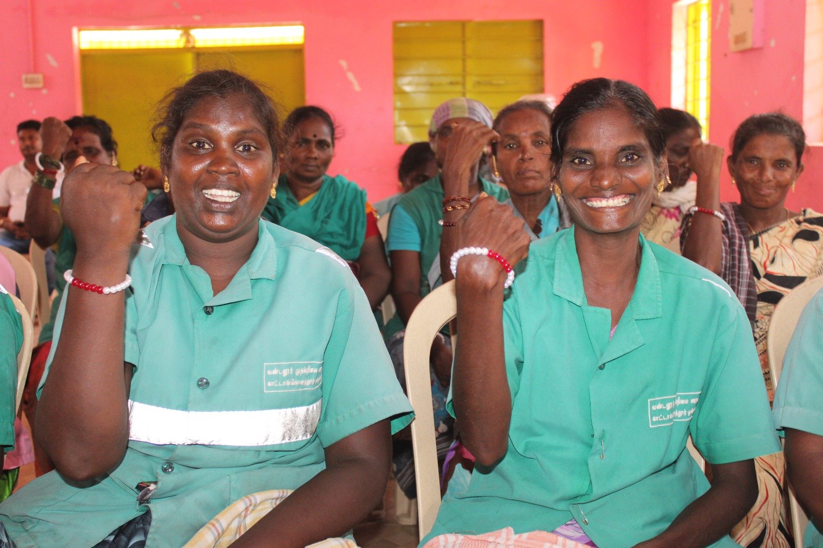 Sanitation workers proudly displaying their menstrual bracelets